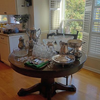 Round pedestal dining table with silverplate and crystal