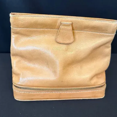 Tan leather handbag with hinged, snap opening 