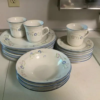 Coordinated Cordella Collection stoneware dinnerware set featuring a delicate blue and pink floral p