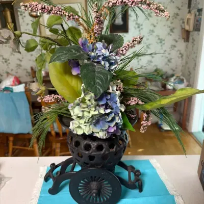 Decorative Floral Arrangement in Ornate Cast Iron Metal Cart Planter