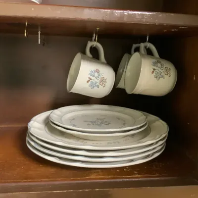 Coordinated Cordella Collection stoneware dinnerware set featuring a delicate blue and pink floral p