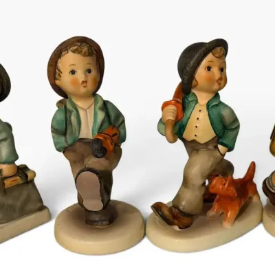 Goebel Hummel “On the Go” Figurine Lot (4) – School Boy, Strolling Along & Other Traveling Boys