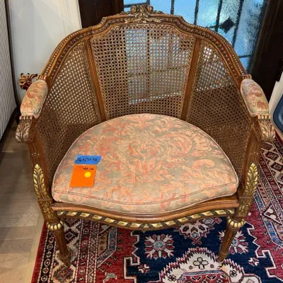 French Louis XV-Style Caned Armchair Featuring Ornate Carved Wooden Frame 