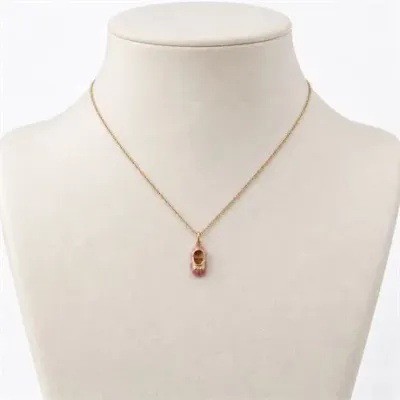 Lot 067   
14K Yellow Gold with Enamel Pink Baby Shoe