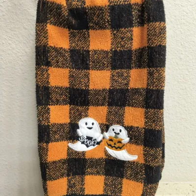 Halloween-themed hand towel featuring an orange and black buffalo plaid pattern with embroidered friendly ghosts.