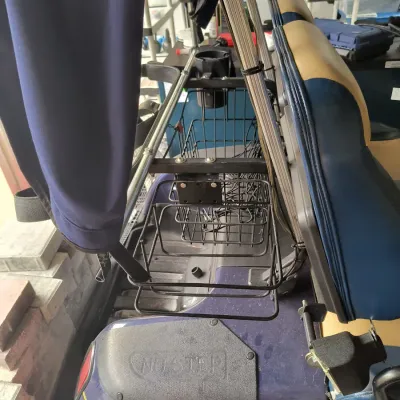 Rear storage basket and cup holder attachment mounted on a blue and tan golf cart.