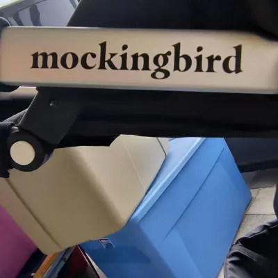 Mockingbird stroller frame showing the brand logo, in gently used condition.