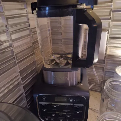 Ninja Foodi Cold & Hot Blender with a glass pitcher, featuring multiple preset programs for crushing and cooking.