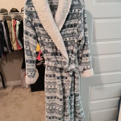 Plush fleece bathrobe featuring a grey and white fair isle pattern, a white sherpa-lined collar and cuffs, and a matching waist tie.