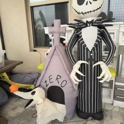 Inflatable Halloween yard decorations featuring Jack Skellington and Zero with his doghouse from The Nightmare Before Christmas.