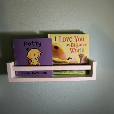 Two children's board books, "Potty" by Leslie Patricelli and "I Love You as Big as the World" by David Van...