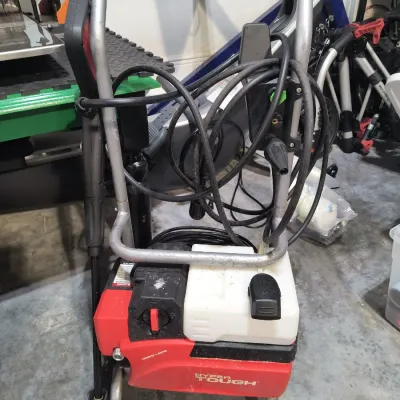 Hyper Tough electric pressure washer with spray wand, hose, and power cord, showing some signs of use.