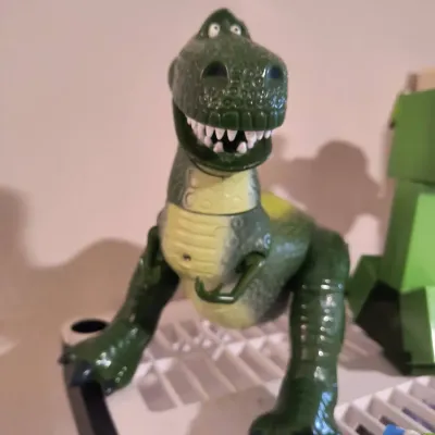 Disney Pixar Toy Story Rex the Dinosaur plastic action figure, showing some light wear.
