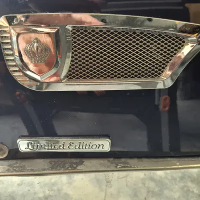 Close-up of a vintage vehicle's chrome fender vent with a crown emblem and a "Limited Edition" script badge below.
