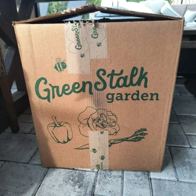 GreenStalk Garden planter system, packaged in its original cardboard shipping box.