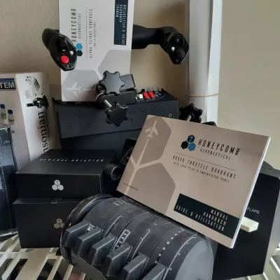 Honeycomb Aeronautical flight simulation gear, including the Alpha Flight Controls yoke and Bravo Throttle Quadrant with original manuals.