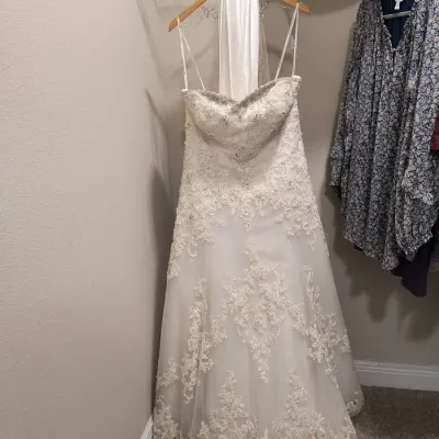 Strapless A-line wedding gown featuring intricate lace overlays, a beaded sweetheart neckline, and a matching satin hanger wrap.