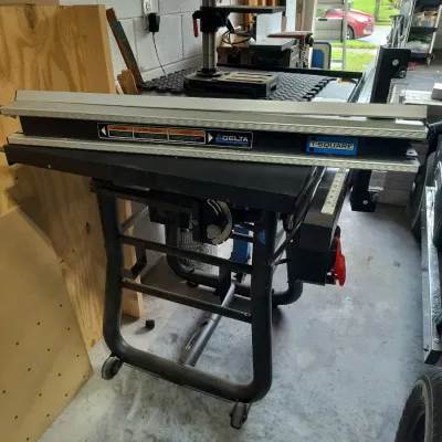 Delta table saw featuring a T-Square fence system, mounted on a mobile wheeled base.