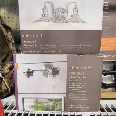 Two boxed Allen + Roth 2-light vanity bars, including the Hainsbrook model in antique pewter and the Vallymede model in brushed nickel...