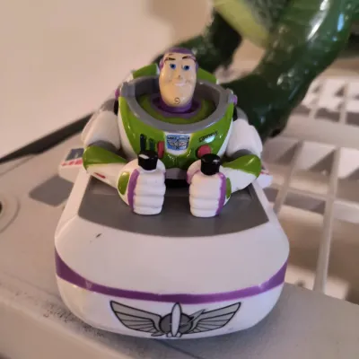 Vintage Disney Toy Story Buzz Lightyear spaceship toy, showing some light wear from play.