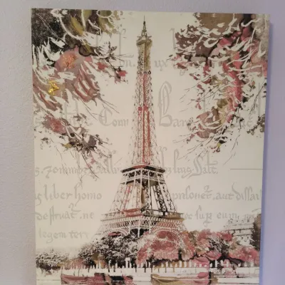 Contemporary canvas wall art featuring a stylized depiction of the Eiffel Tower in Paris with script overlay and pink floral accents.