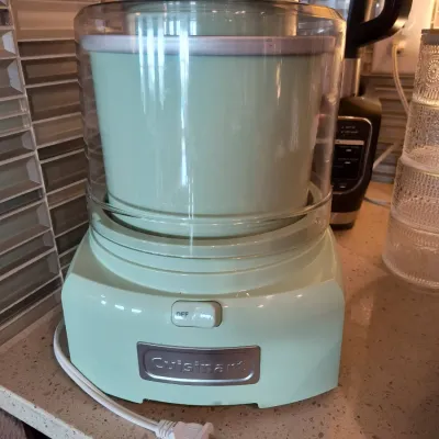 Cuisinart automatic frozen yogurt, ice cream, and sorbet maker in a retro mint green color, appearing in clean, gently used condition.