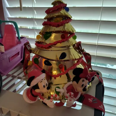 Disney Parks collectible Christmas tree popcorn bucket featuring Mickey and Minnie Mouse figures holding candy canes, complete with a...