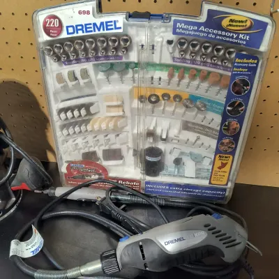 Dremel 400 XPR rotary tool with flexible shaft attachment and a 220-piece Dremel Mega Accessory Kit in its original plastic storage case.