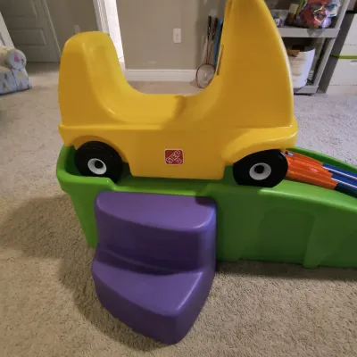 Step2 Up & Down Roller Coaster toy featuring a yellow coaster car, green track, and purple steps, in gently used condition.