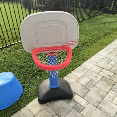 Little Tikes Easy Score toddler basketball hoop with a blue, red, and grey plastic frame, complete with a white net.