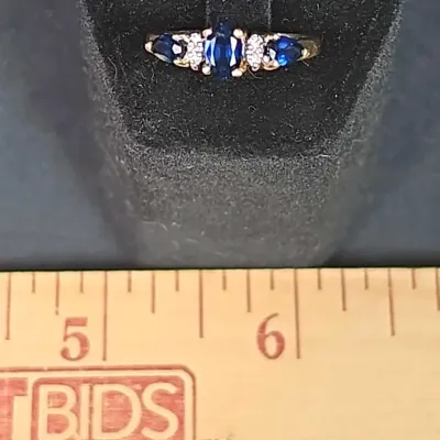 14k Yellow Gold Ring with Three Sapphire Stones and Four Clear Accent Gems. Size 7 Weighs 2.6g