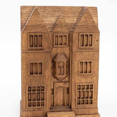 A LARGE WOODEN CHARITY CONTAINER IN THE SHAPE OF 770 CHABAD