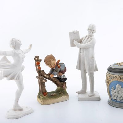A BEER STEIN WITH A SIX POINTED STAR AND OTHER FIGURINES