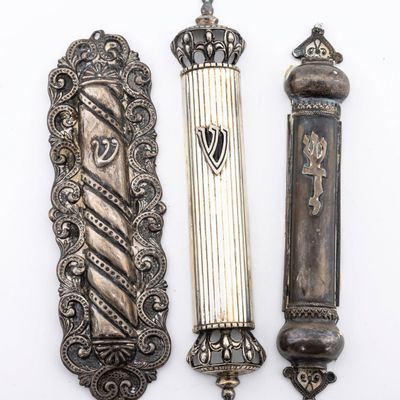 A GROUP OF THREE STERLING SILVER MEZUZAH COVERS