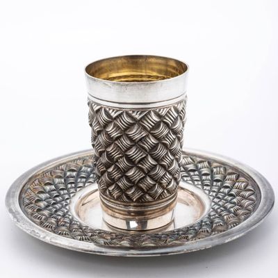 A STERLING SILVER KIDDUSH CUP AND PLATE BY HADDAD BROTHERS.