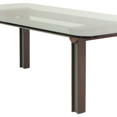 A CUSTOM ART DECO INSPIRED TABLE IS COMPRISED OF A GLASS TOP AND A MIXED METAL BASE