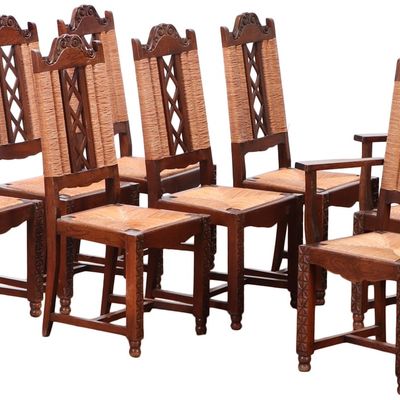Sale Photo Thumbnail #321: EIGHT FRENCH OAK AND RUSH DINING CHAIRS INCLUDING TWO ARM CHAIRS IN THE MANNER OF DUDOUYT C 1940.
