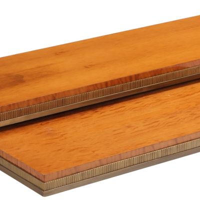 TWO MID CENTURY MODERN SAPELE WOOD PARTIALLY NESTING TABLES HAVING HEAVY BRONZE TRIM AND LEGS