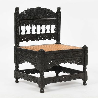 Sale Photo Thumbnail #158: An Anglo-Indian Carved Ebony Low Chair, 19th Century