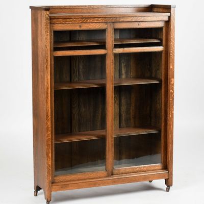 Sale Photo Thumbnail #114: An Oak Two Door Sliding Bookcase