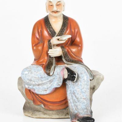 Sale Photo Thumbnail #170: A Chinese Famille Rose Porcelain Figure of a Seated Scholar, 19th Century/ Early 20th Century