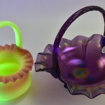 PAIR OF FENTON ART GLASS BASKETS: AMETHYST CARNIVAL GLASS AND BURMESE GLASS