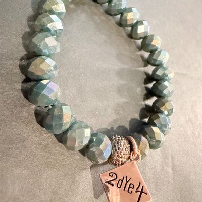 beaded stretch bracelet featuring faceted, blue-green or sage-colored glass or crystal beads, accented with a rose gold-toned pave bead...