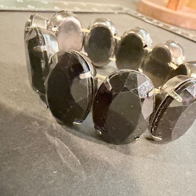 Black gemstone type silver tone stretch bracelet