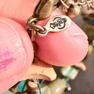 Premier Designs Island Girl Bracelet, featuring a multi-strand design with green and blue ceramic or glass beads and shell accents