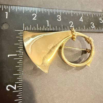 Gold tone vintage instrument brooch