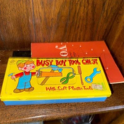 Vintage Busy Boy Tool Chest toy box with colorful graphics, featuring a yellow lid and blue base, shown alongside a vintage book on a...