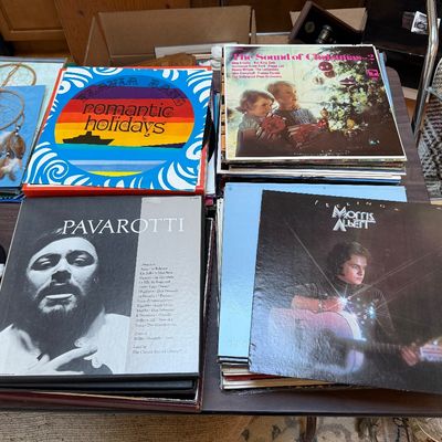 A collection of vintage vinyl record albums, including Pavarotti, Morris Albert, and "The Sound of Christmas," displayed on a...
