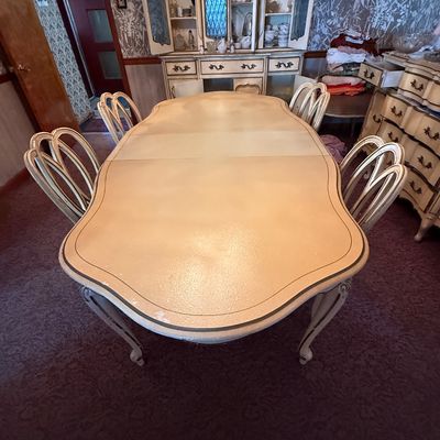 Vintage French Provincial style dining table with one leaf and four matching balloon-back chairs, featuring a cream-painted finish with...