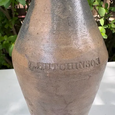 E. HUTCHINSON STONEWARE BOTTLE 10 1/2"